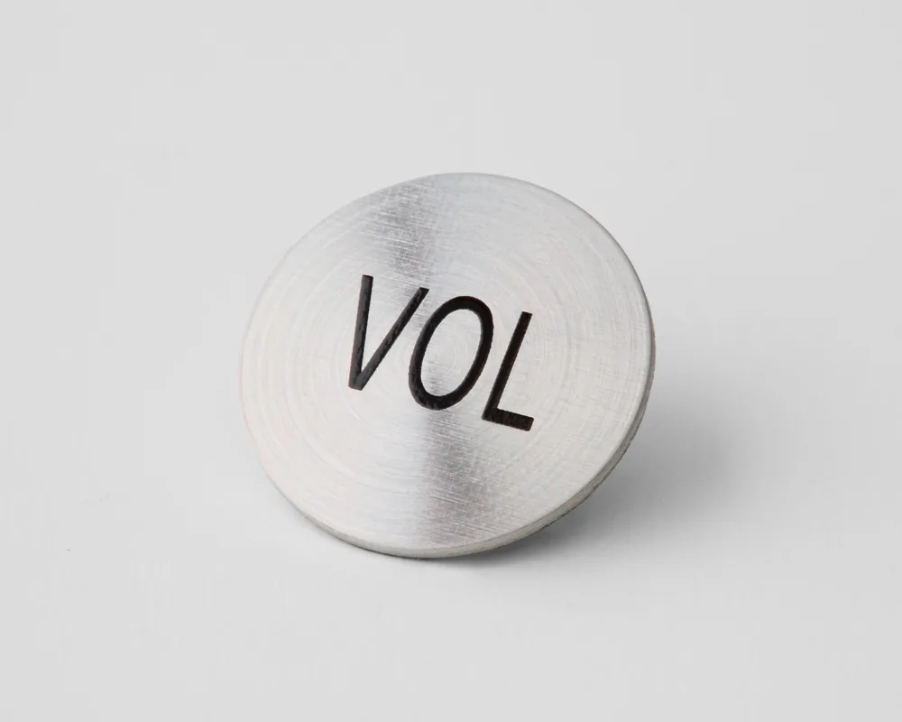 Round VOL aluminum control badge
