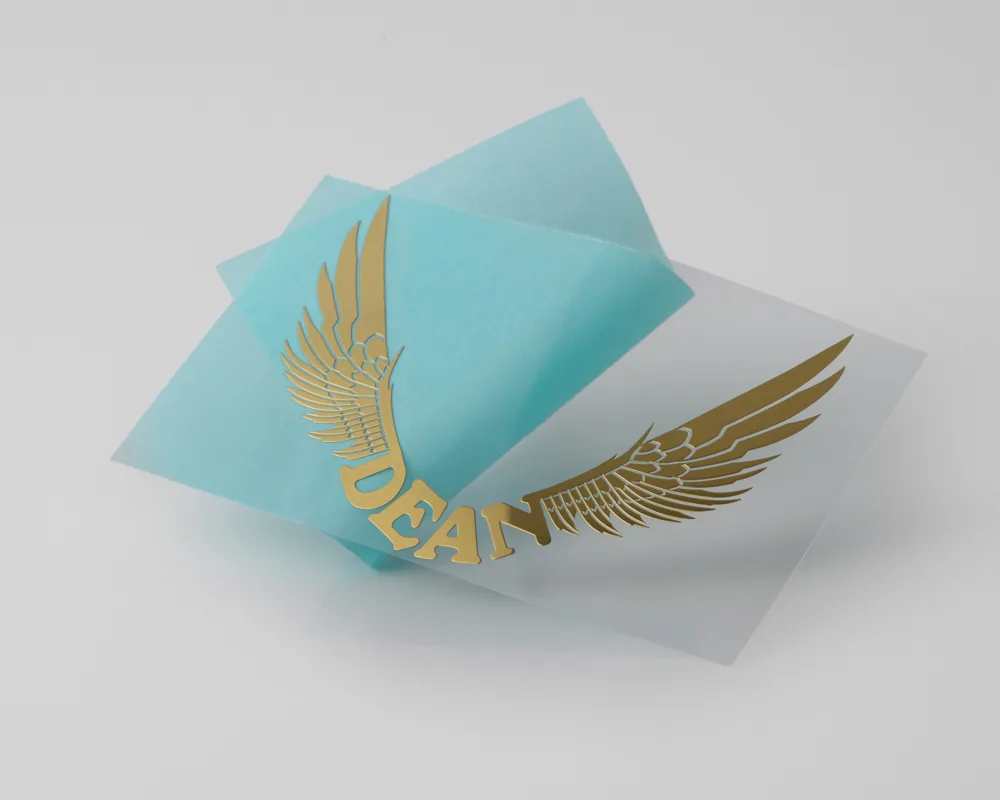 Thin gold electroformed wing emblem on transfer film